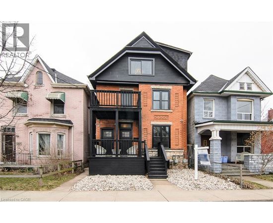 A house with a black front door and steps.