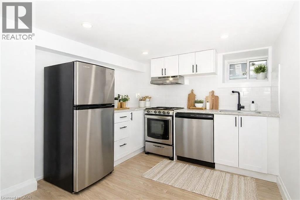 A modern kitchen with a stainless steel refrigerator, oven, and microwave.