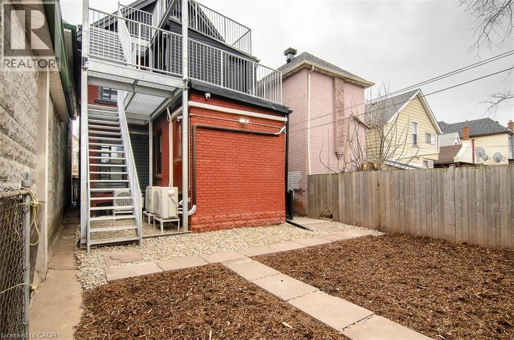 A red garage door is on the side of a building.