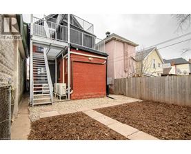 A red garage door is on the side of a building.