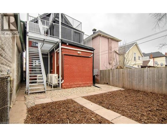 A red garage door is on the side of a building.