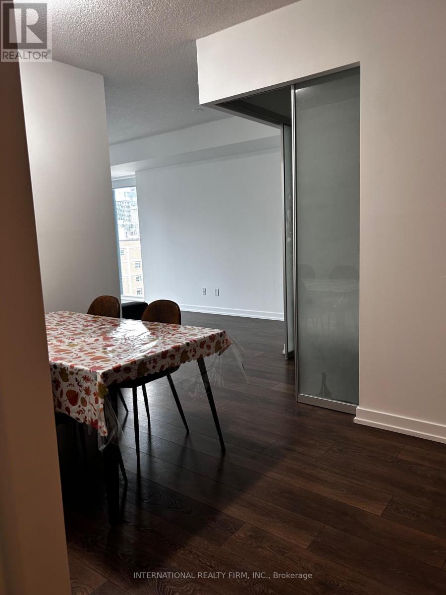 A dining room with a table set for two.
