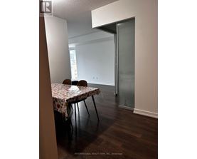 A dining room with a table set for two.