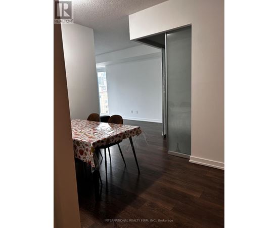 A dining room with a table set for two.