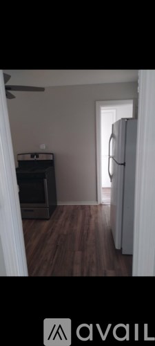 A room with wooden flooring and a white door.