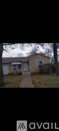 A beige house with a white door and a small porch.