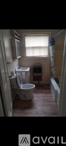 A bathroom with a toilet, sink, and bathtub.