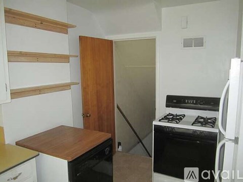 A kitchen with a stove and a refrigerator.