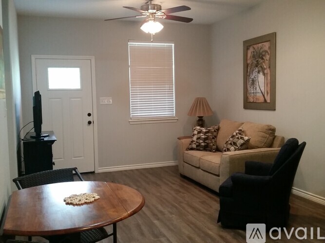 A living room with a couch, chair, and television.