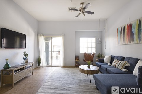 A living room with a blue couch and a wooden coffee table.