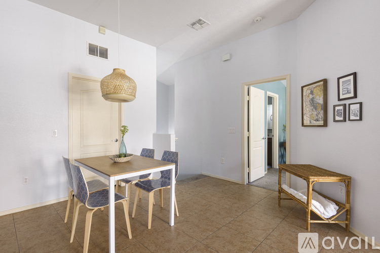 A dining room with a table and chairs.