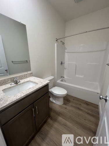 A bathroom with a toilet, sink, and bathtub.