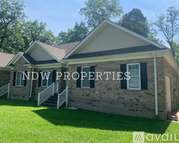 A house with the text "NDW PROPERTIES" on the side.