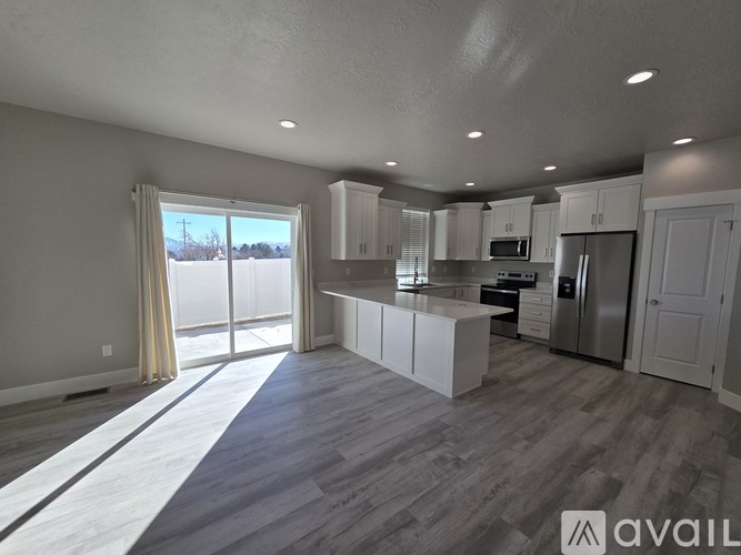 A spacious kitchen with white cabinets and a large island.