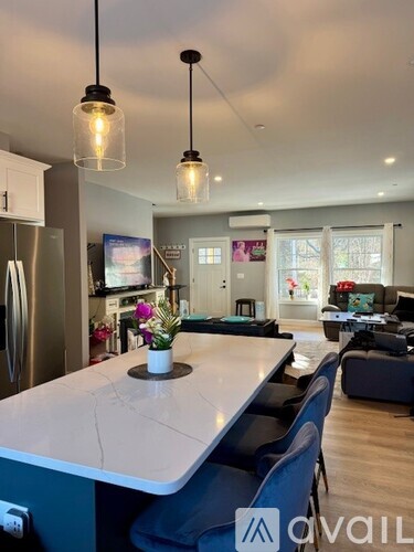 A kitchen with a marble countertop and a refrigerator.