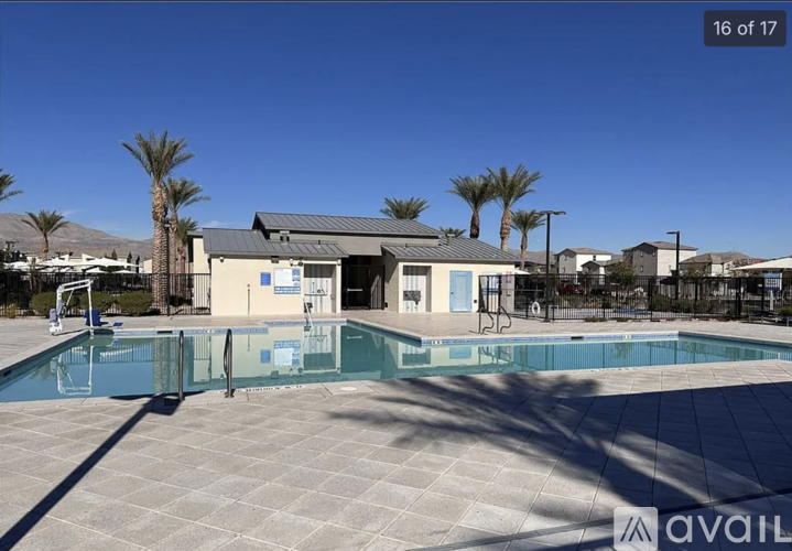 A pool area with a building and palm trees.