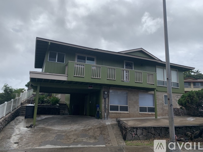 A two-story house with a balcony on the second floor.