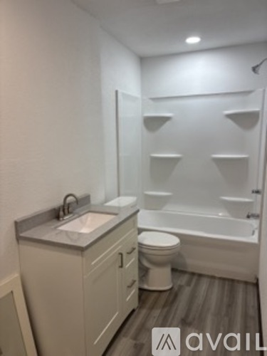 A bathroom with a toilet, sink, and bathtub.