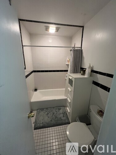 A small bathroom with a toilet, sink, and bathtub.