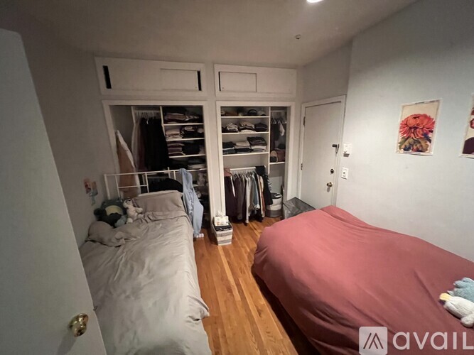A bedroom with two beds and a wardrobe.