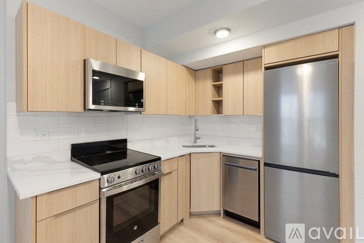 A kitchen with wooden cabinets and stainless steel appliances.