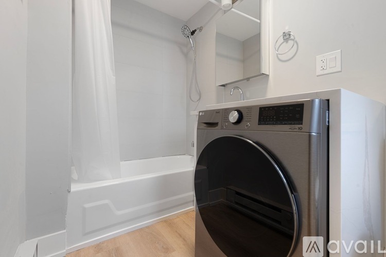 A washing machine is in a small laundry room.