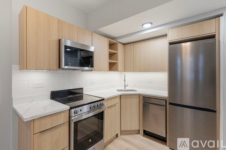 A kitchen with wooden cabinets and stainless steel appliances.