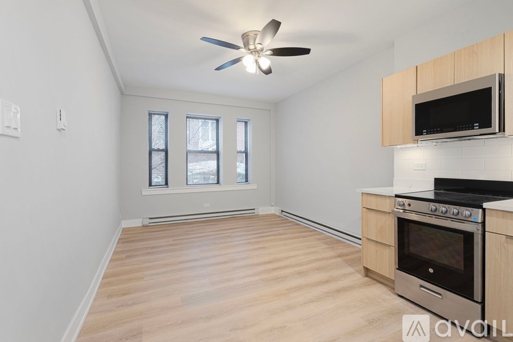 A kitchen with a fan and a stove top oven.