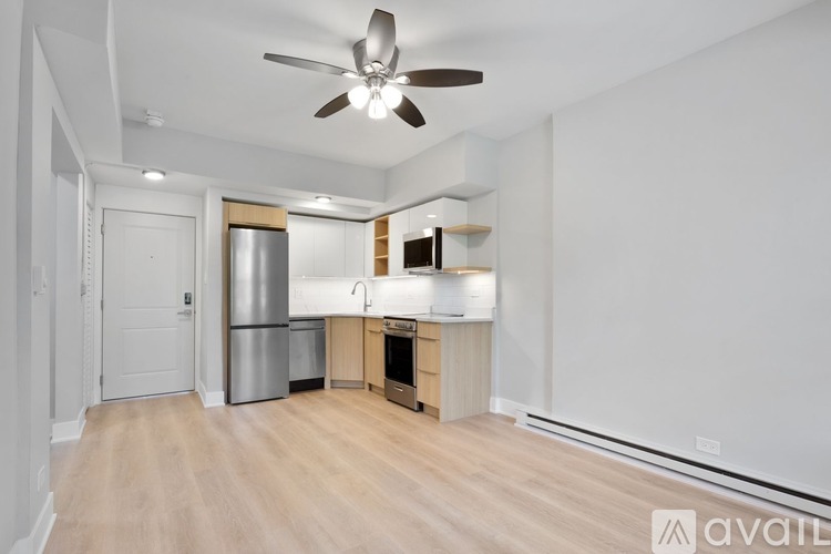 A kitchen area with a refrigerator, oven, and sink.