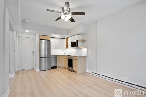 A kitchen area with a refrigerator, oven, and sink.