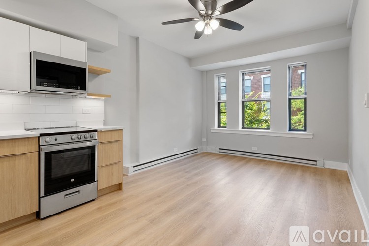 A kitchen with a stove, oven, and microwave.