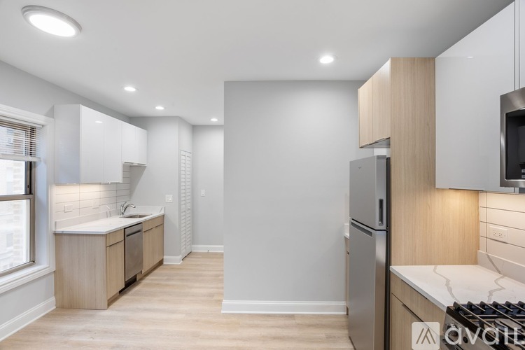 A modern kitchen with wooden cabinets and stainless steel appliances.