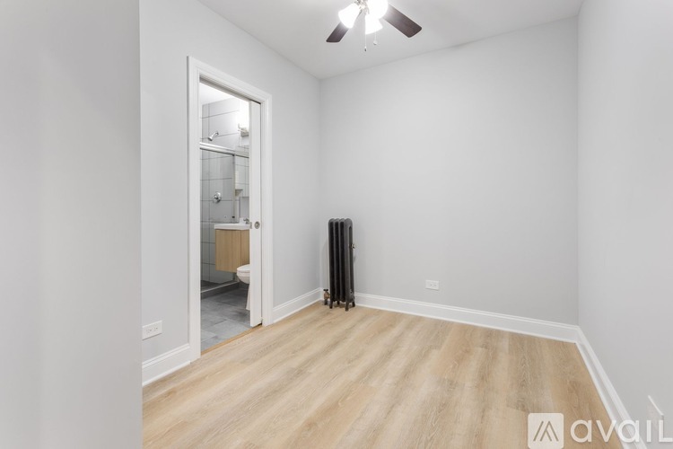 A room with a wooden floor and a ceiling fan.