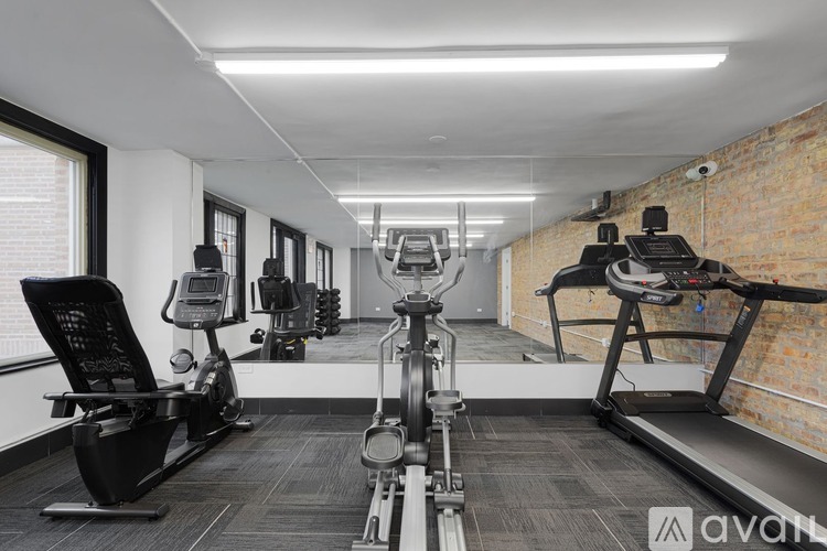 A gym with treadmills, elliptical machines, and other exercise equipment.