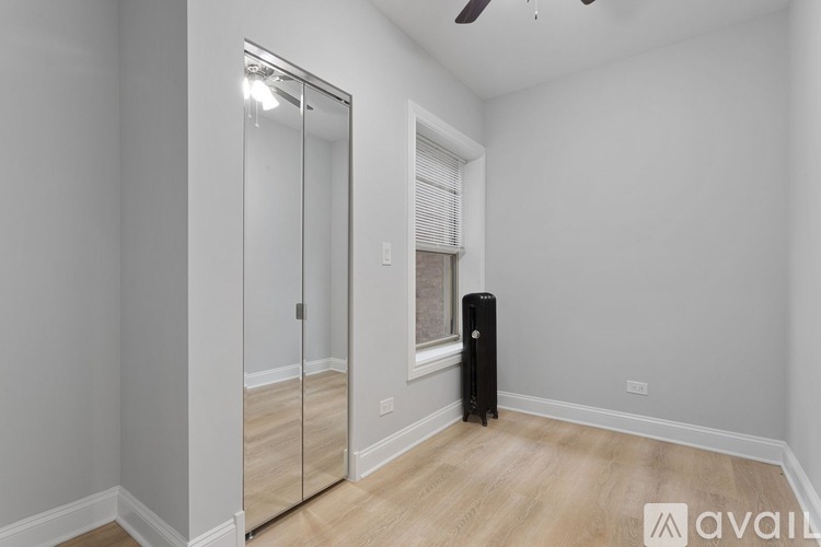 A room with a sliding door and a black object on the floor.