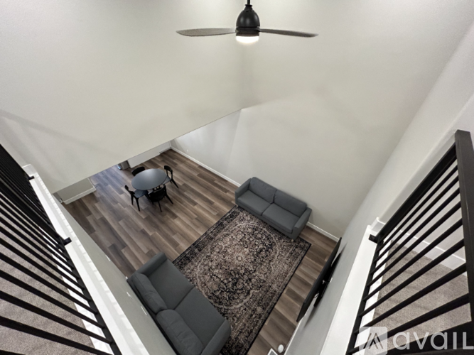 A living room with a couch and a rug.