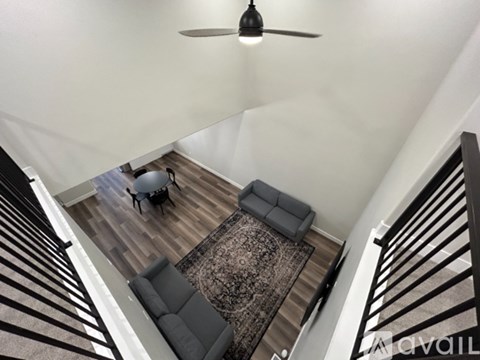 A living room with a couch and a rug.
