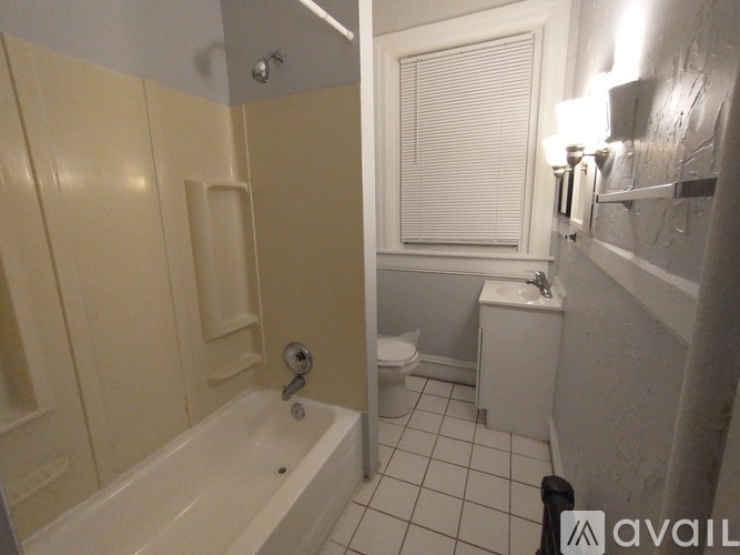 A bathroom with a tub and toilet.