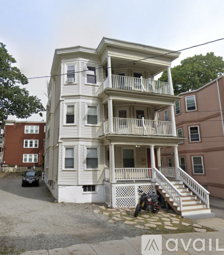 A three-story building with a balcony on the second floor.