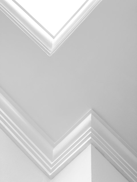 A white wall with a chevron pattern.