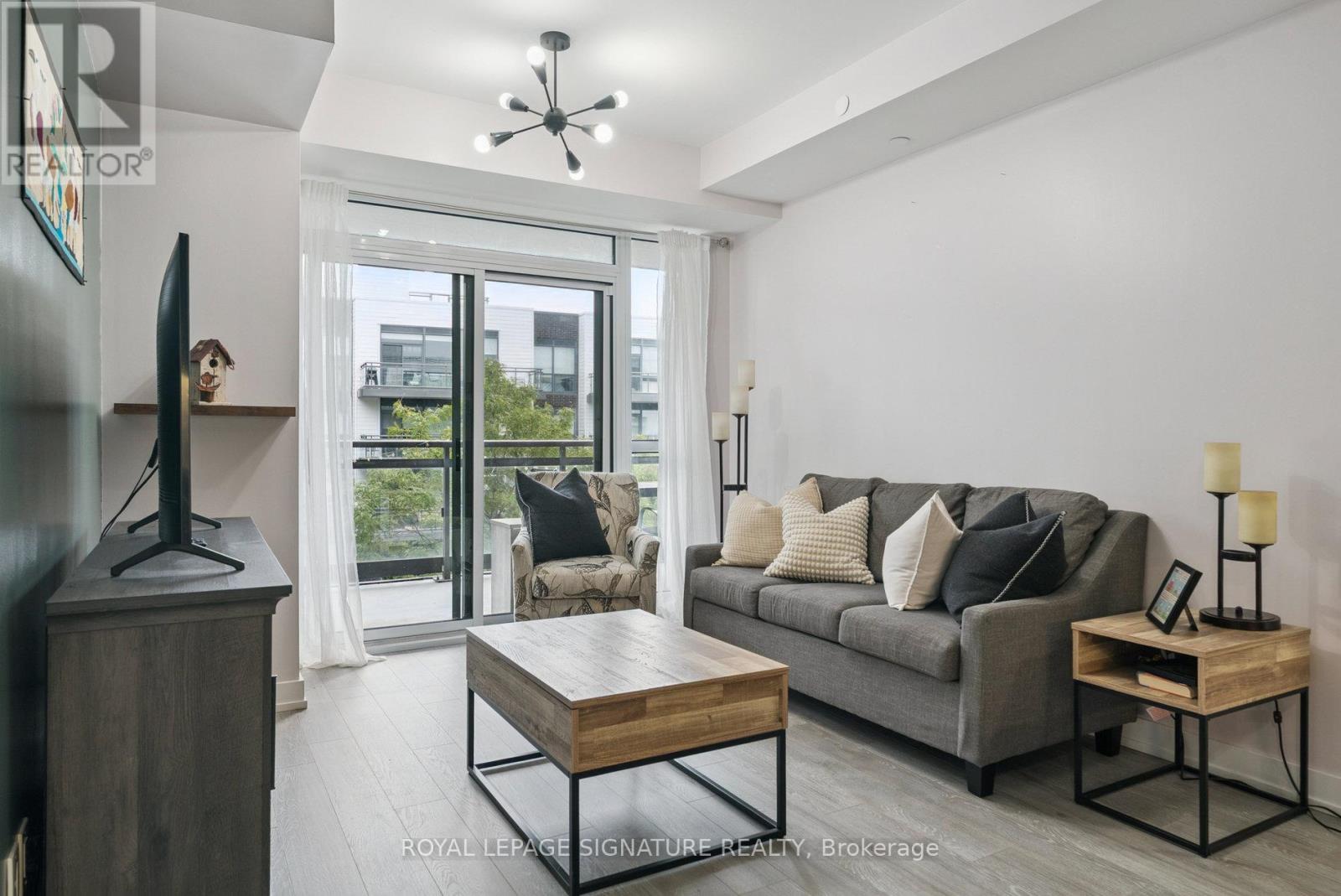 A living room with a grey couch and a wooden coffee table.