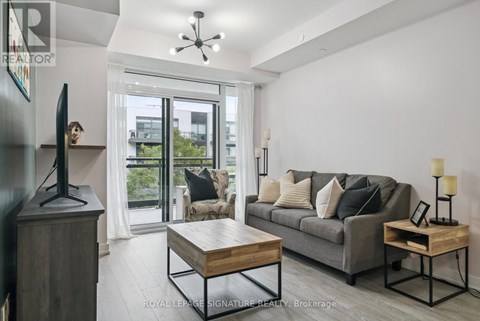 A living room with a grey couch and a wooden coffee table.