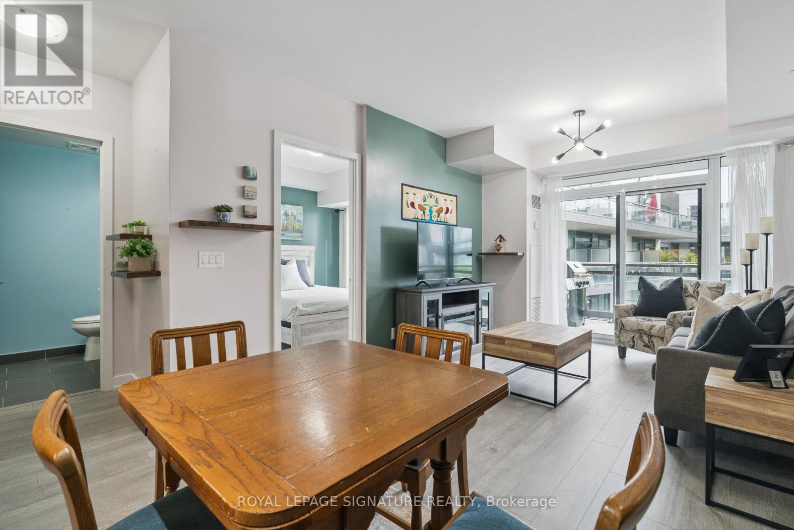 A dining room with a wooden table and chairs.