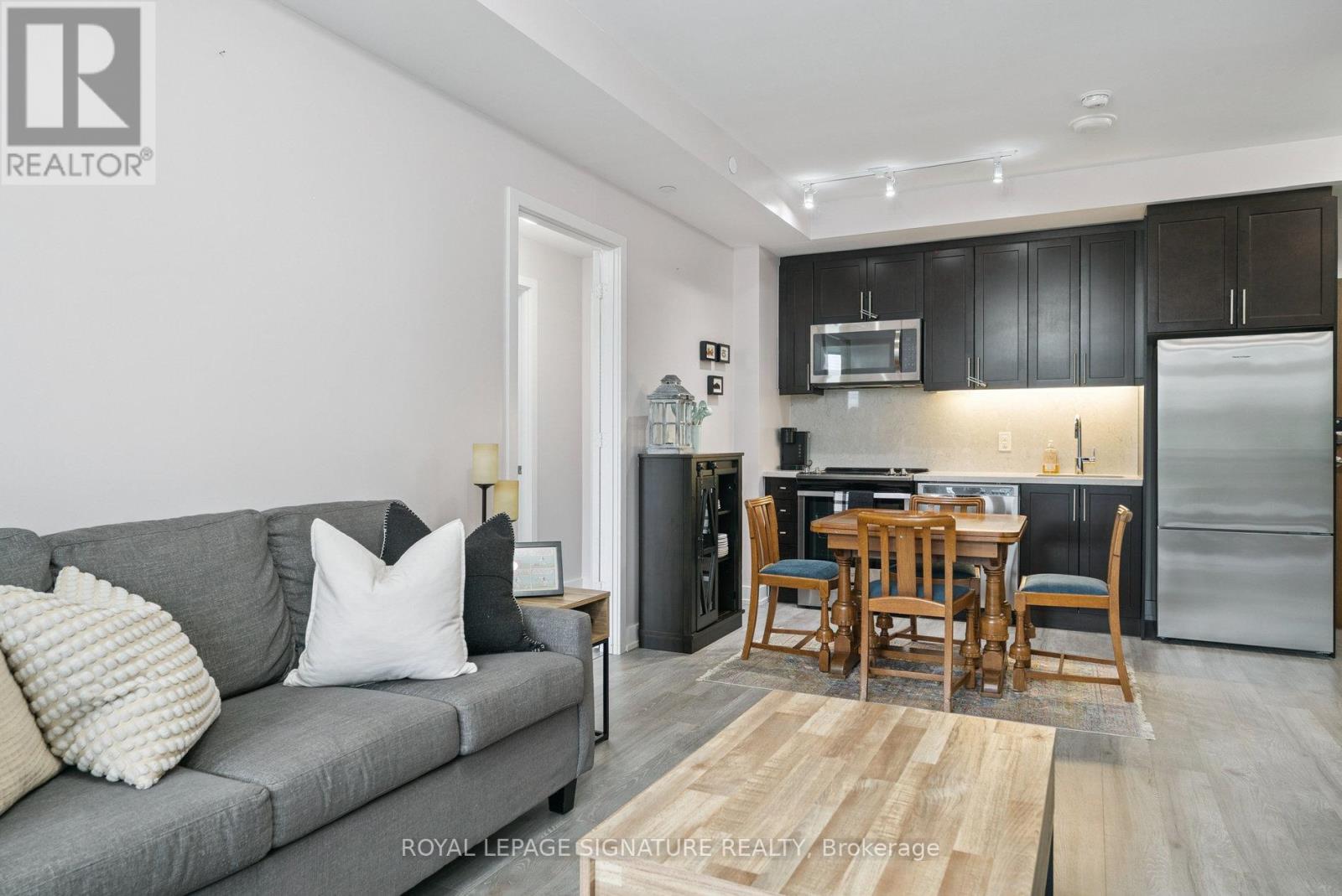 A modern kitchen with a dining table and chairs.
