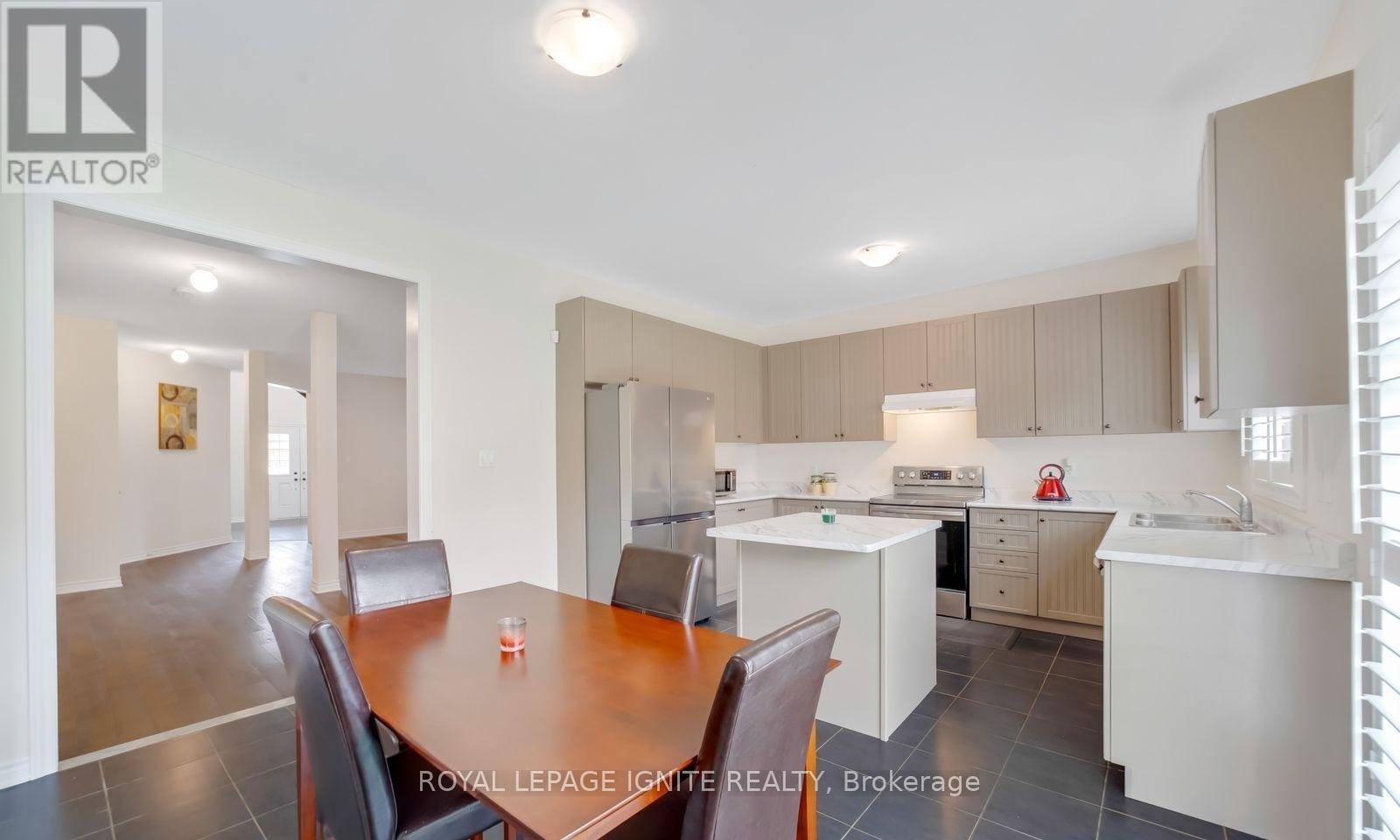 A well-lit kitchen and dining area with a table set for two.