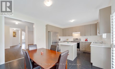 A well-lit kitchen and dining area with a table set for two.