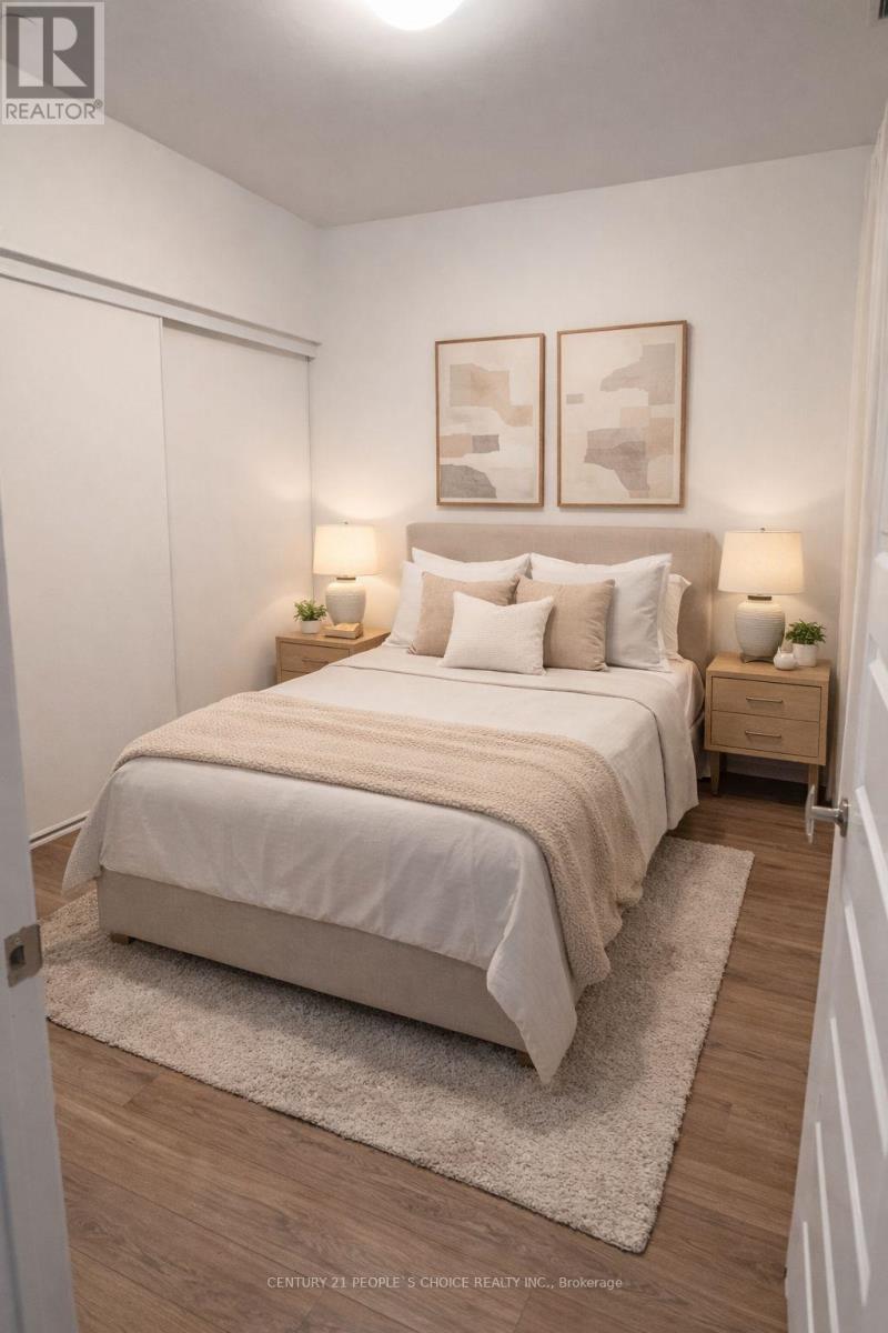 A bedroom with a bed, two lamps, and two framed pictures on the wall.