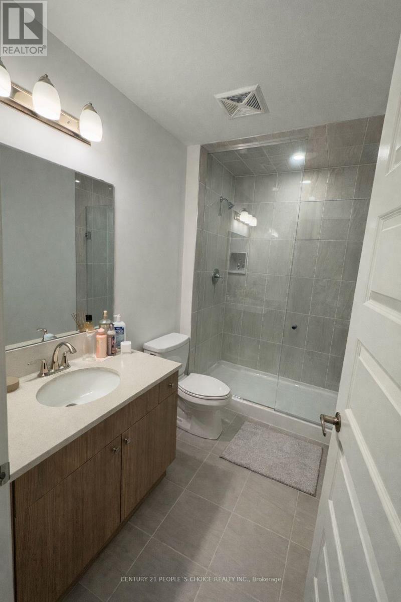A bathroom with a sink, toilet and shower.