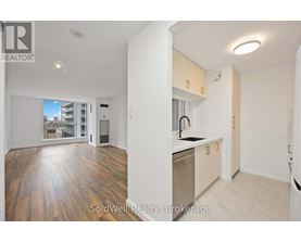 A kitchen with wooden floors and white walls.