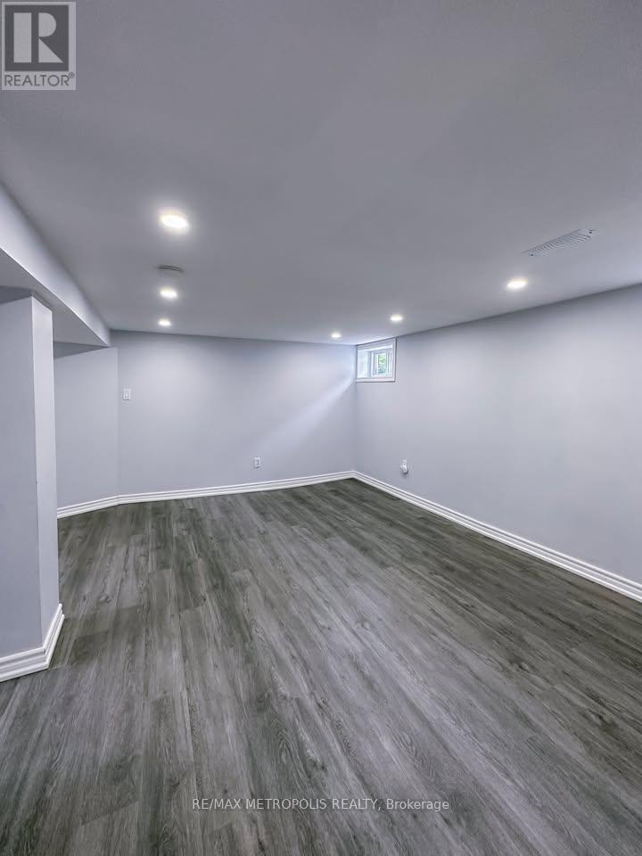 A room with grey flooring and white walls.